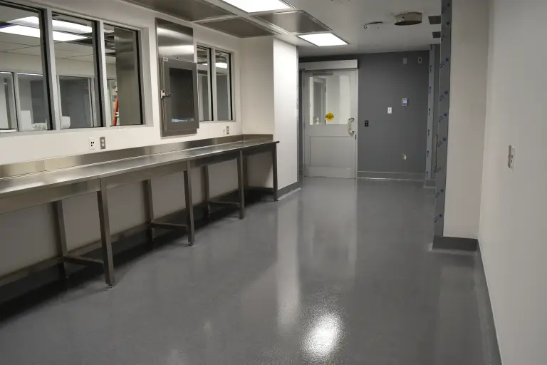 Double broadcast epoxy quartz floor coating with 6 inch cove in a hospital pharmacy