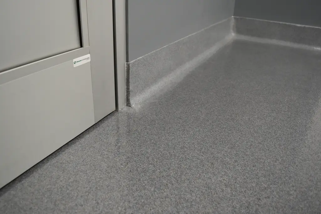 Double broadcast epoxy quartz floor coating with integrated cove in a medical facility