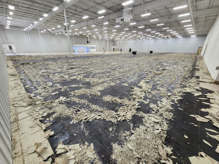 Large scale flooring removal with a ride-on floor scraper